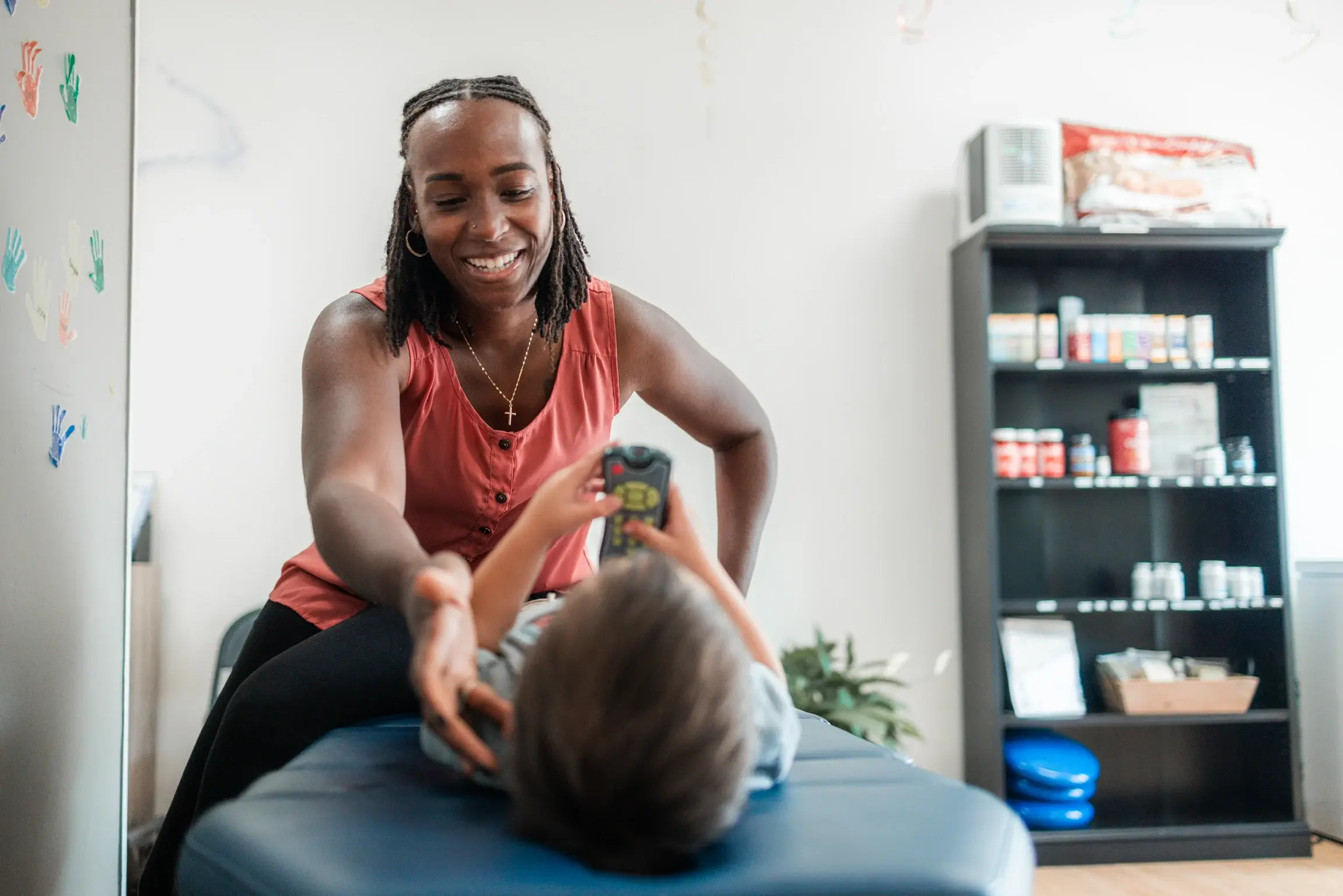Chiropractor adjusting a young patient
